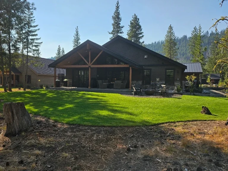 Well-maintained residential lawn with visible mow lines in front of a modern home.